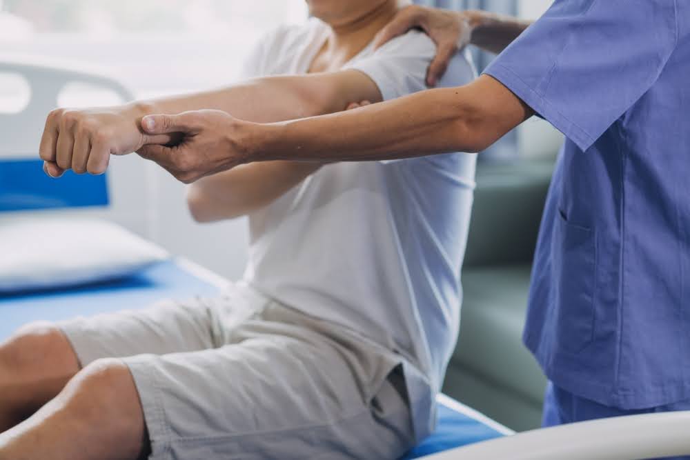 Physiotherapist working with patient in clinic