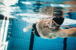 Physiotherapy exercises for lower back pain - a man swimming in a pool