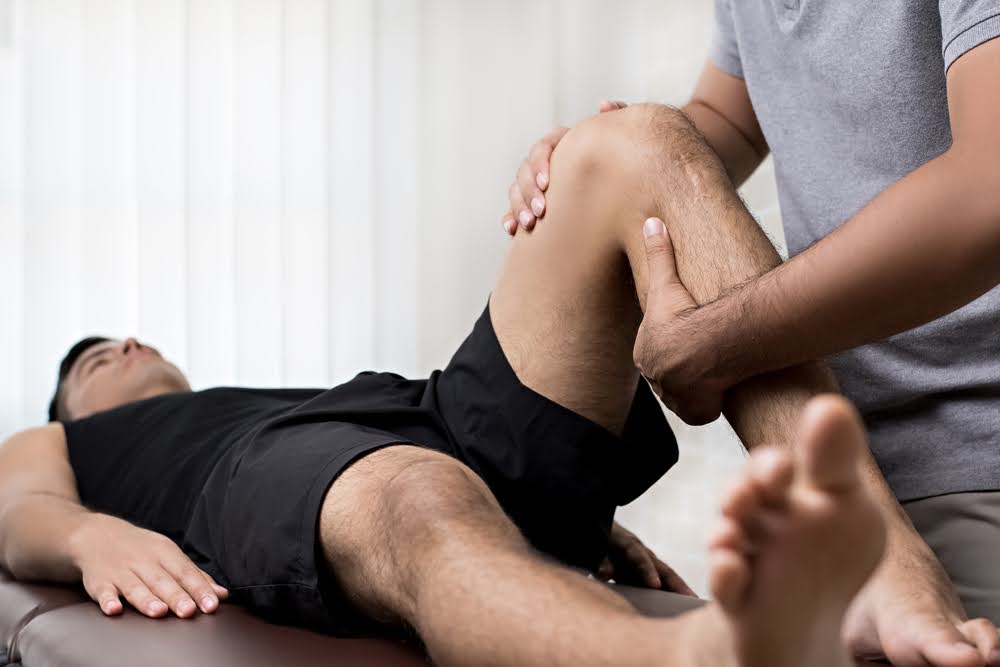 A man enjoying the benefits of physical therapy for athletes.