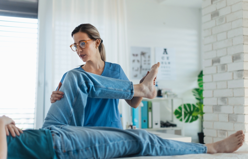 Physiotherapist doing manual therapy exercise